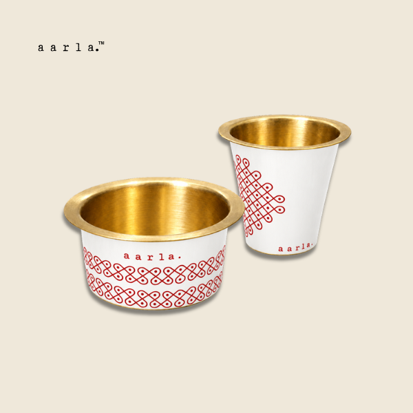 Aarla White Kolam brass dabara tumbler set on beige background