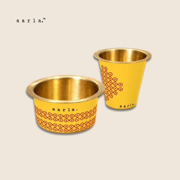 Aarla Yellow Kolam brass dabara tumbler set on beige background