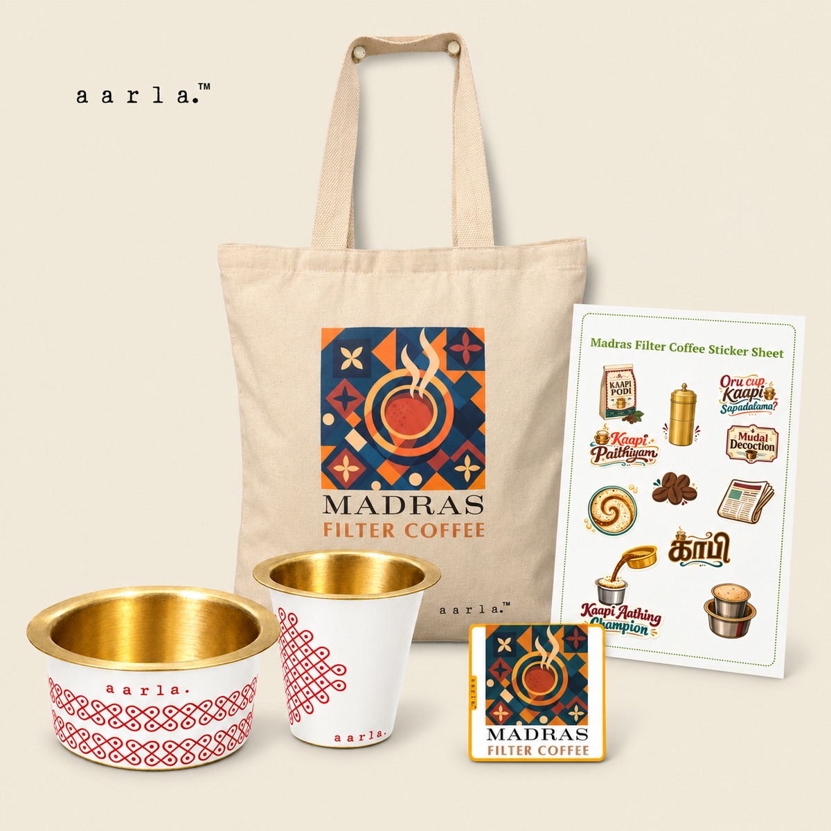 Kaapi Time Diwali gift hamper: 1 White Kolam brass dabara-tumbler set — one tumbler and one dabara; 1 Madras Filter Coffee canvas tote; 1 Madras Filter Coffee fridge magnet — 2.5 × 2.5 inches; 1 Filter Coffee sticker sheet — 4 × 6 inches